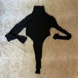 Very high-cut thong black turtleneck body suit
